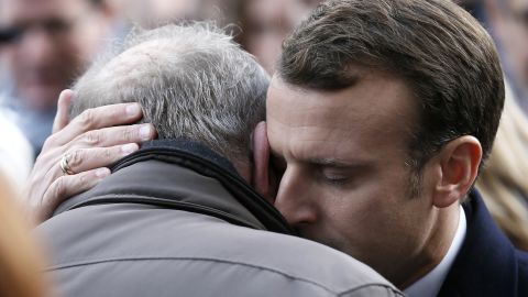 French President Emmanuel Macron hugs a relative of a victim at the Bataclan concert hall during a ceremony Monday. 