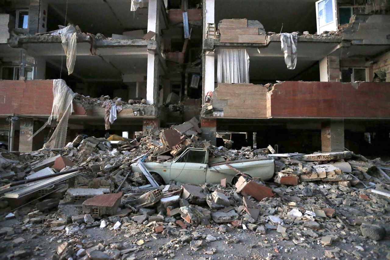 A crushed car is seen among the debris in Sarpol-e-Zahab on November 13.