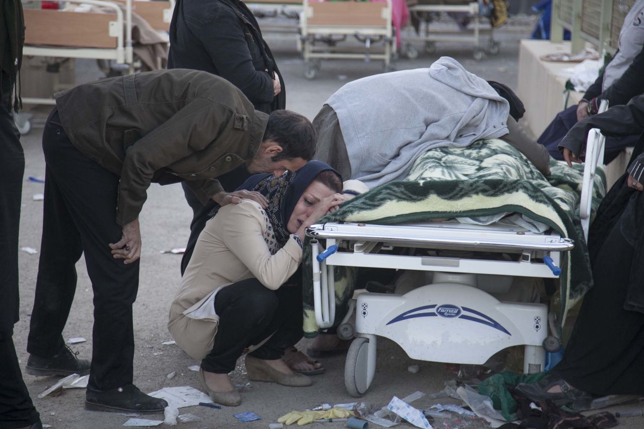 People mourn over the body of a quake victim in Sarpol-e Zahab on November 13.