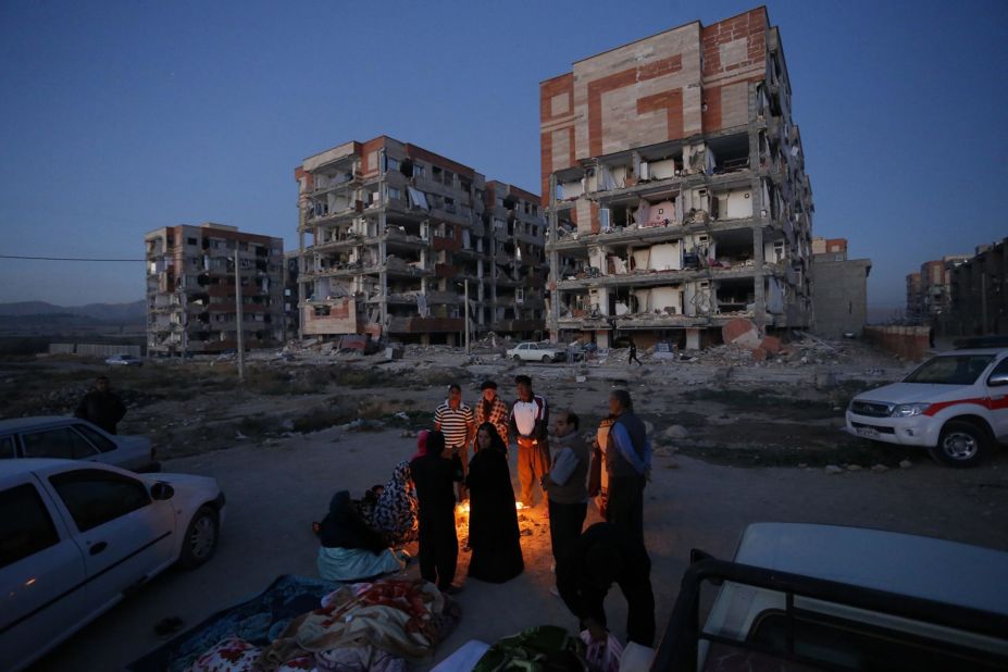 Residents of Sarpol-e Zahab huddle by a fire after the earthquake.