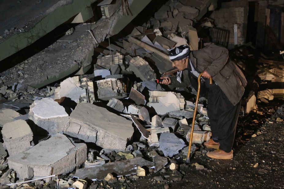 A man searches the rubble for survivors in Iraq's Darbandikhan district.