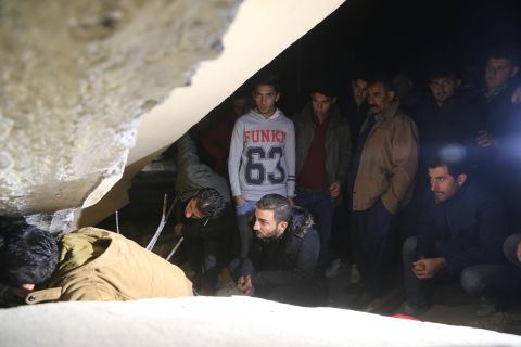 People in Sulaimaniya search for people trapped in rubble on November 12.