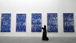 A visitor takes a photo of a piece of a series of nine panels titled "Untitled I-IX" by American artist Cy Twombly at the Louvre Abu Dhabi Museum on November 11, 2017 during its official opening to the public on Saadiyat island in the Emirati capital. 
More than a decade in the making, the Louvre Abu Dhabi opened its doors bringing the famed name to the Arab world for the first time. / AFP PHOTO / GIUSEPPE CACACE / RESTRICTED TO EDITORIAL USE - MANDATORY MENTION OF THE ARTIST UPON PUBLICATION - TO ILLUSTRATE THE EVENT AS SPECIFIED IN THE CAPTION        (Photo credit should read GIUSEPPE CACACE/AFP/Getty Images)
