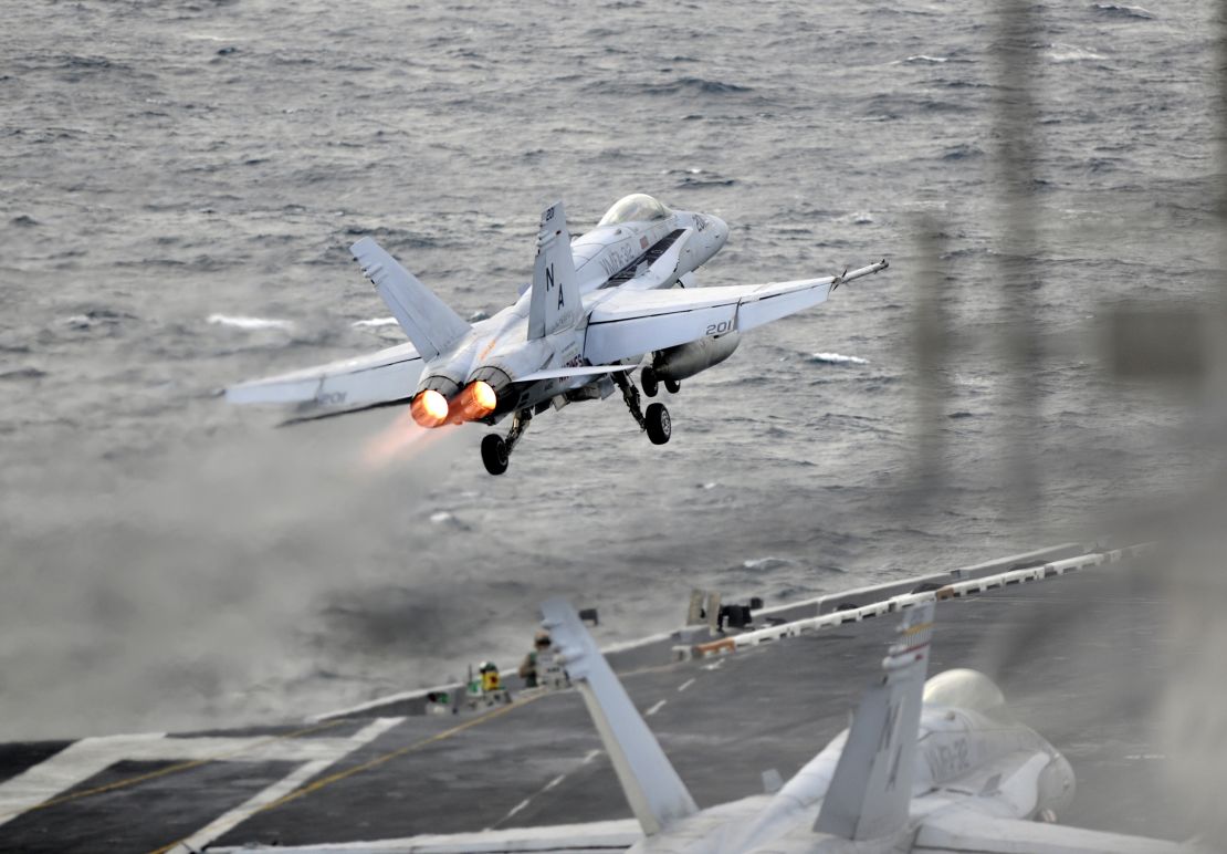An F/A-18E Super Hornet launches from the flight deck of the USS Theodore Roosevelt.