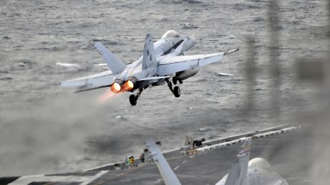An F/A-18E Super Hornet launches from the flight deck of the USS Theodore Roosevelt.