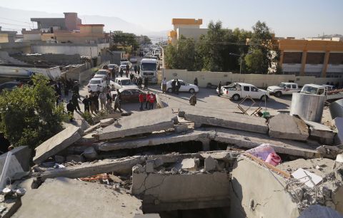 Emergency responders gather near collapsed buildings in the Darbandikhan district of Iraq's Sulaimaniya province.