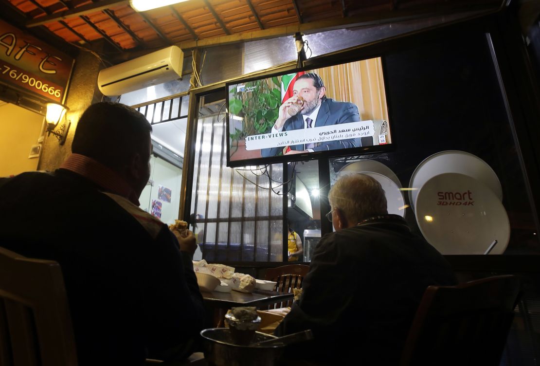 Lebanese watch an interview with Lebanon's resigned prime minister Saad Hariri at a coffee shop in Beirut on November 12, 2017.
