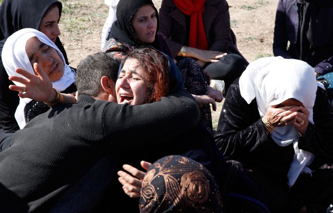 People cry near the wreckage of their home in Sarpol-e Zahab on November 13.