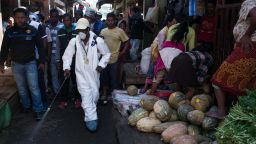 People stand back as a council worker sprays disinfectant during the clean-up of the market of Anosibe in the Anosibe district, one of the most unsalubrious districts of Antananarivo on October 10, 2017.
The World Health Organization has warned that a deadly outbreak of the plague, which began in late August, has claimed more than 20 lives in Madagascar and is swiftly spreading in cities across the country. Rats are porters of fleas which spread the bubonic plague and are attracted by garbages and unsalubrity. Pneumonic plague, which is passed through person-to-person transmission, has also been recorded. / AFP PHOTO / RIJASOLO        (Photo credit should read RIJASOLO/AFP/Getty Images)
