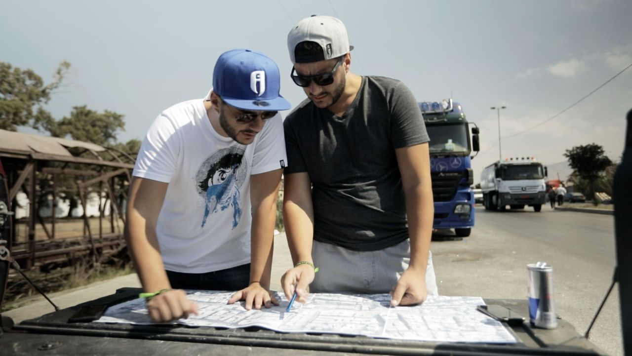 Mohamed (right) and Omar Kabbani look at plans for their Operation Salam artwork.