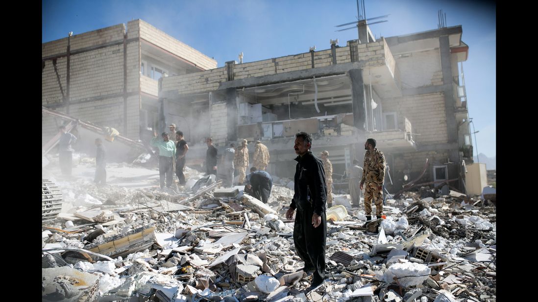 People walk through rubble in Sarpol-e Zahab on November 13. 