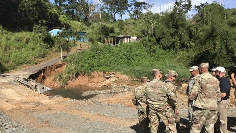 Buchanan and colleagues survey a damaged road in Maricao.