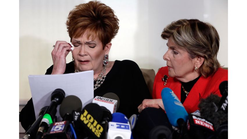 Beverly Young Nelson, left, the latest accuser of Alabama Republican Roy Moore, reads her statement as attorney Gloria Allred looks on, at a news conference, in New York, Monday, Nov. 13, 2017. Nelson says Moore assaulted her when she was 16 and he offered her a ride home from a restaurant where she worked. Moore says the latest allegations against him are a "witch hunt." (AP Photo/Richard Drew)