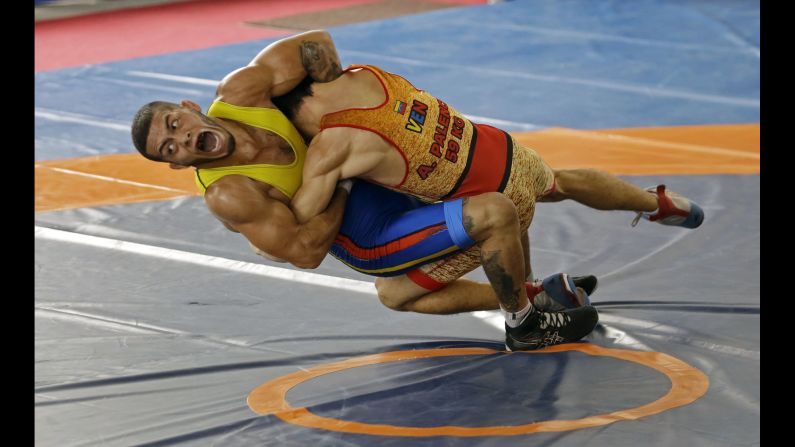 Colombian wrestler Dicter Toro, left, competes against Venezuela's Anthony Palencia during the annual Bolivarian Games on Sunday, November 12. This year's events are taking place in Santa Marta, Colombia.