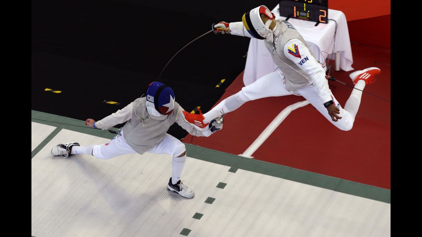 Venezuelan fencer Antonio Leal, right, takes on Chile's Ruben Silva at the Bolivarian Games on Sunday, November 12.