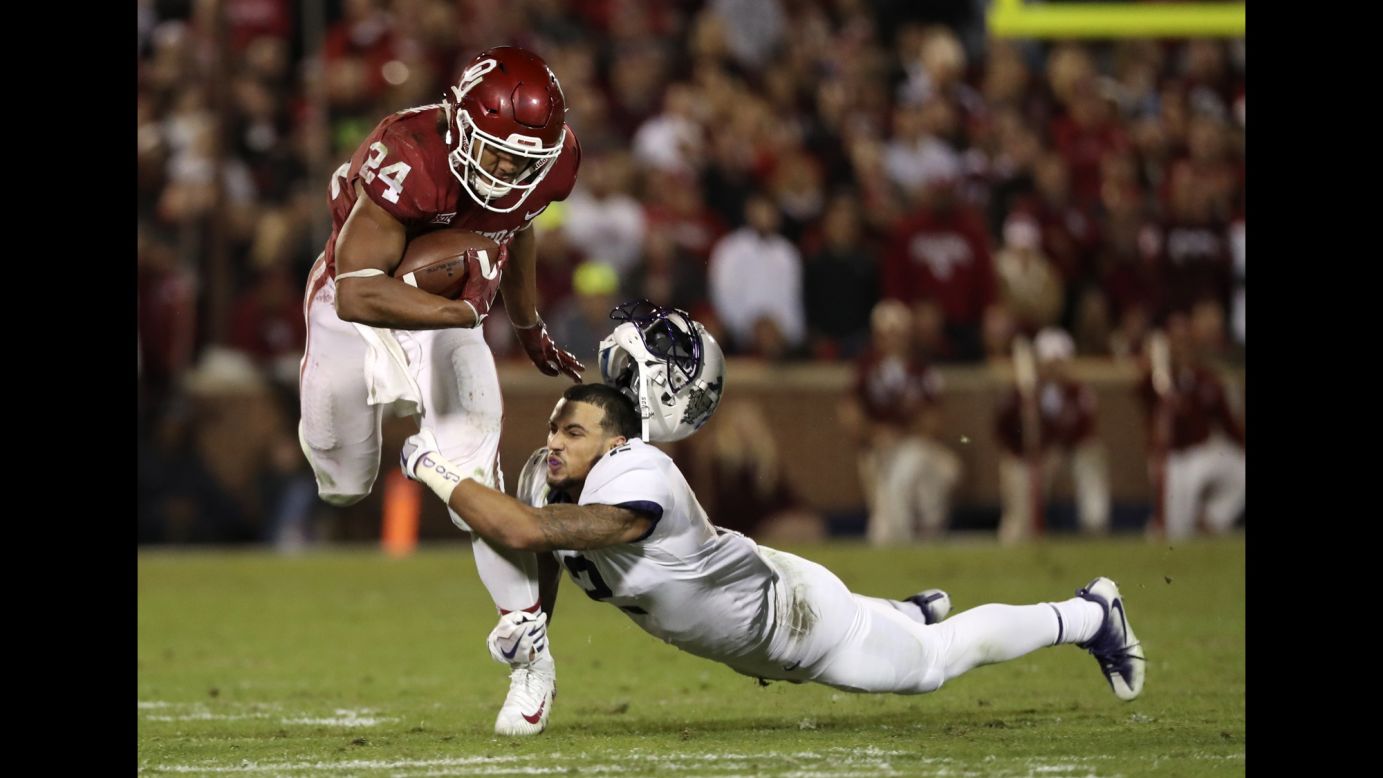TCU safety Niko Small loses his helmet while trying to tackle Oklahoma's Rodney Anderson on Saturday, November 11. Anderson scored four touchdowns as Oklahoma won 38-20 and took sole possession of first place in the Big 12 Conference.