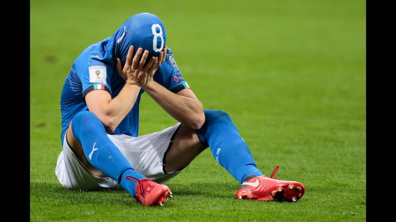 Alessandro Florenzi covers his face after Italy lost its World Cup playoff to Sweden on Monday, November 13. For the first time since 1958, Italy will not be appearing at the World Cup.