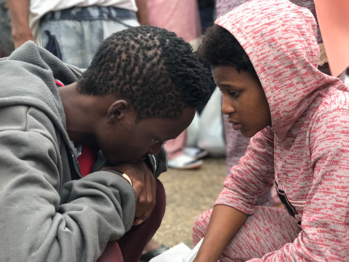 Another woman tearfully says goodbye to her husband as she must also leave the country alone.