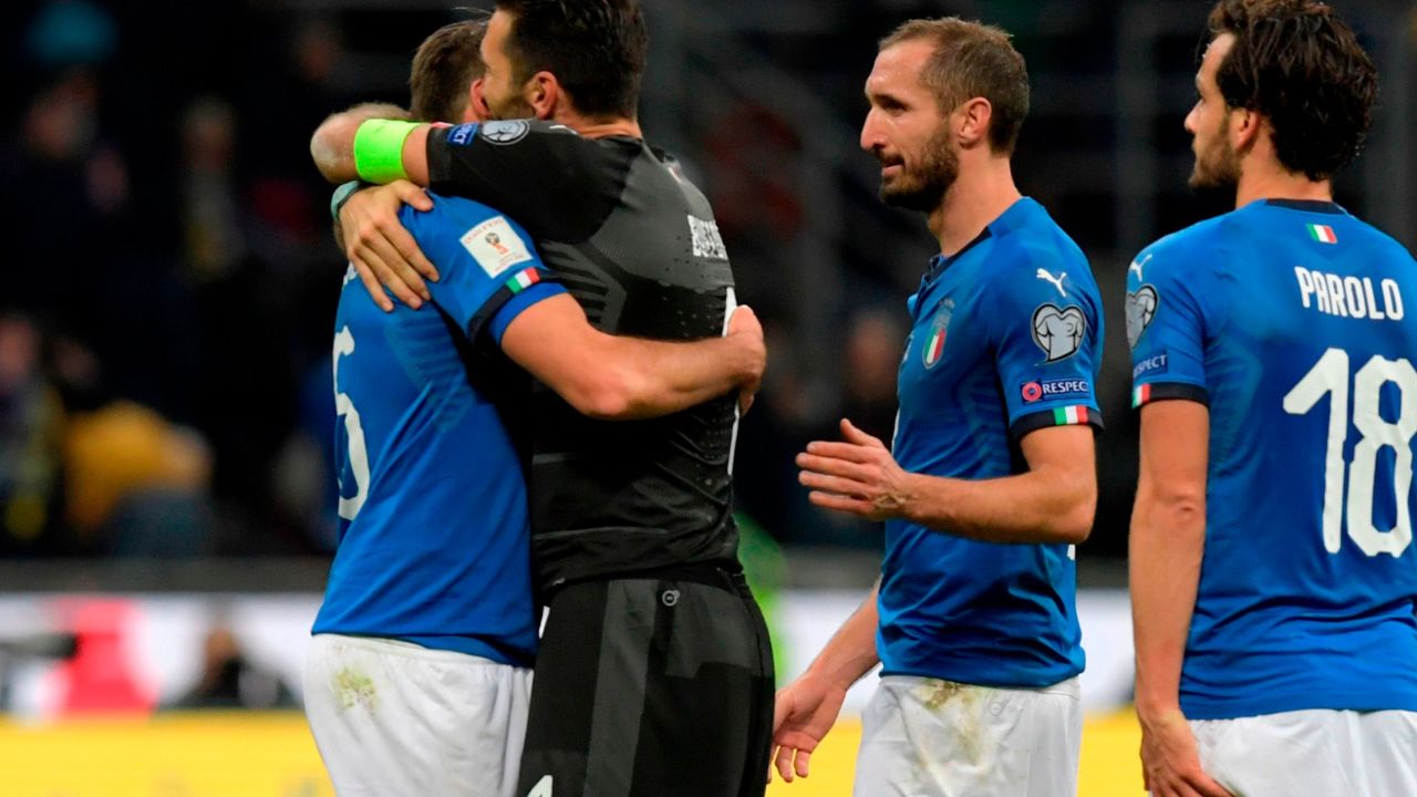 Italians Andrea Barzagli, Gianluigi Buffon, Giorgio Chiellini and Marco Parolo console each other after defeat by Sweden