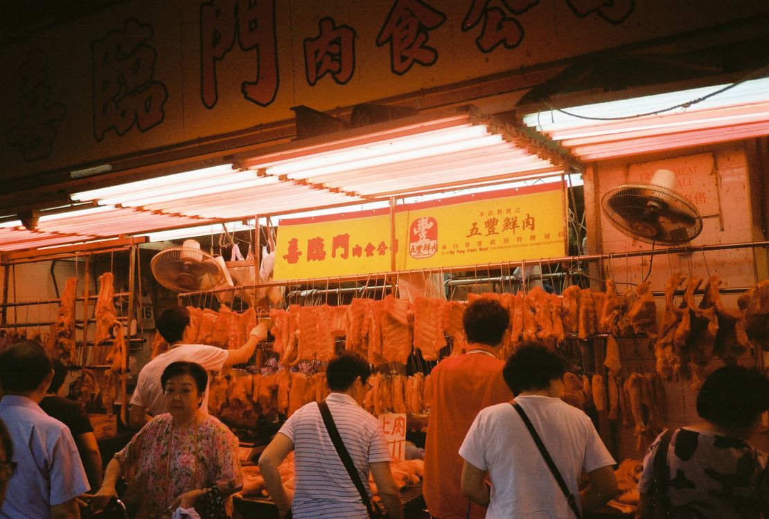 Fresh Meat: Shoppers trying to find the best cuts at a butchers stall.