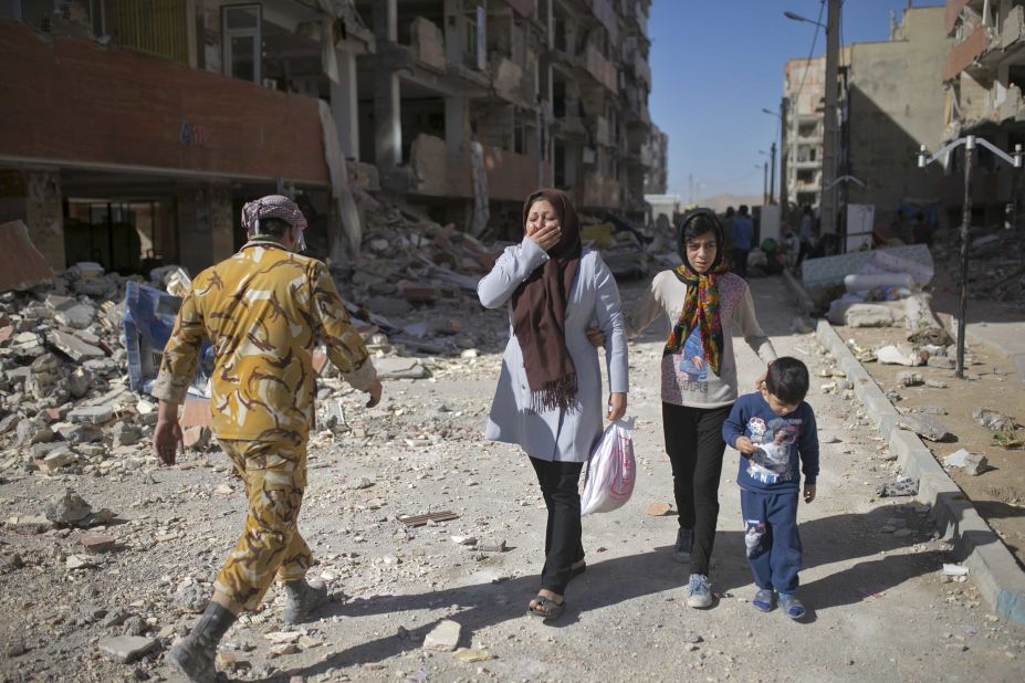 People react as they make their way through Sarpol-e Zahab, Iran, on Tuesday, November 14, two days after a magnitude 7.3 earthquake <a href="http://www.cnn.com/2017/11/14/asia/iran-iraq-earthquake/index.html" target="_blank">devastated the region</a> along the Iran-Iraq border area. Hundreds were killed and thousands were hurt, officials said.