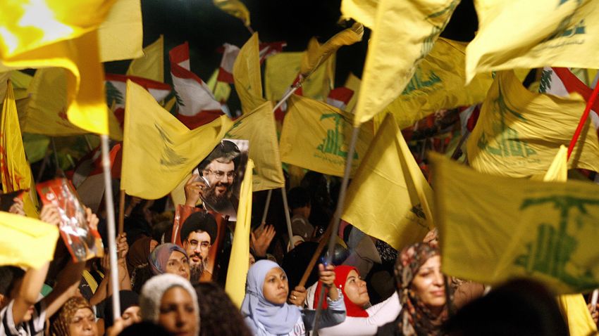 Images of Hezbollah chief Hassan Nasrallah are seen among scores of Hezbollah and Lebanese national flags being waved by Hezbollah supporters during a ceremony to mark first anniversary of the war with Israel, 14 August 2007. Nasrallah reiterated to a mass rally broadcast live on television that his Shiite group had won a divine victory. "Today is the anniversary of the divine victory," Nasrallah told the thousands of men, women and children who had gathered in an empty lot of Beirut's southern suburb of Dahiyeh controlled by Hezbollah. AFP PHOTO/MARWAN NAAMANI (Photo credit should read MARWAN NAAMANI/AFP/Getty Images)