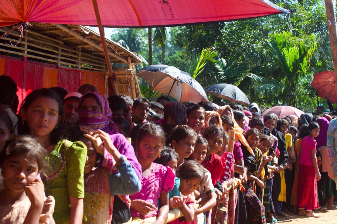 Women and girls wait for food aid in the Kutupalong refugee camp. The lines are segregated by gender.