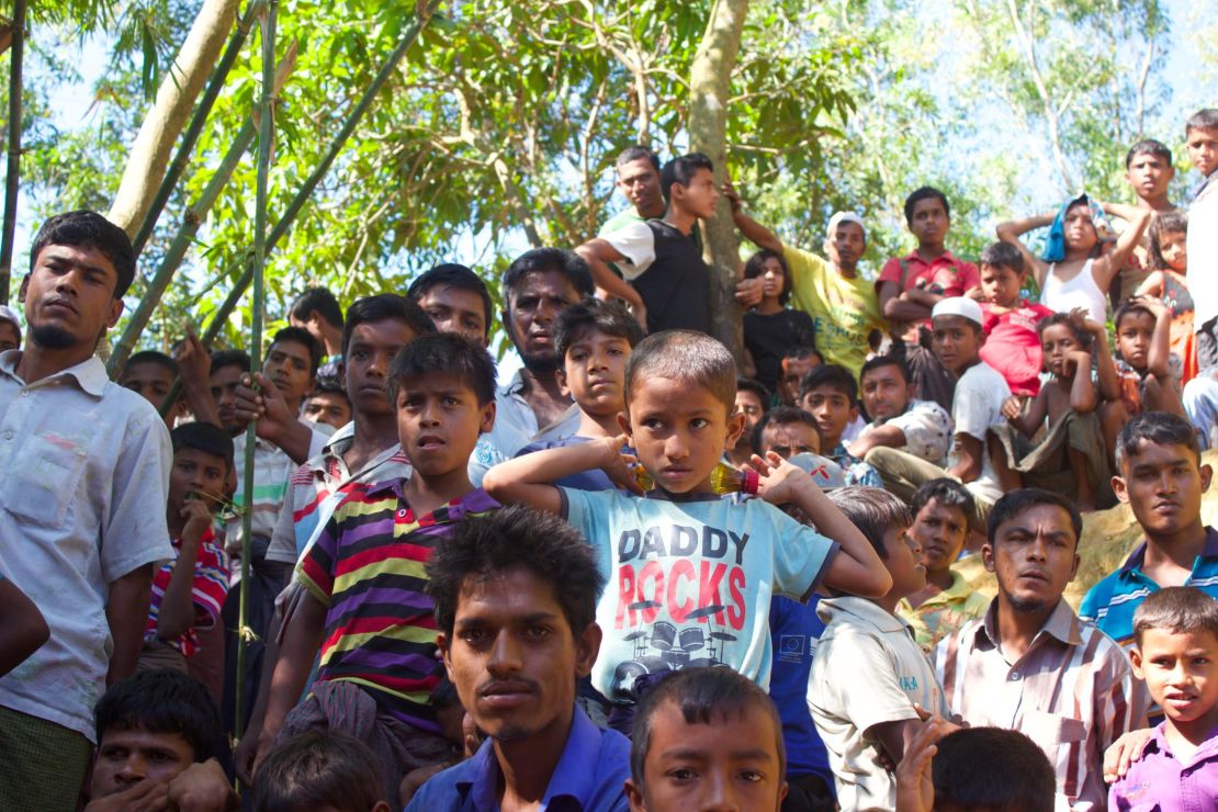 Men and boys without ration cards look on at a food distribution seeking an opportunity to cut in. The UN World Food Programme reports 1 in 4 children in these refugee camps is malnourished.