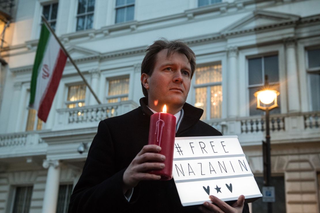 Richard Ratcliffe, husband of Nazanin Zaghari-Ratcliffe holds a '#Free Nazanin' sign and candle.