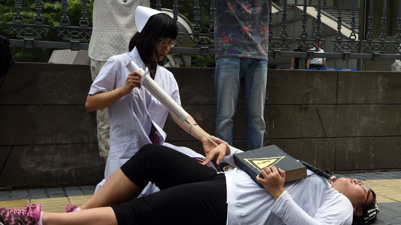 Activists stage a protest against so-called gay conversion therapies outside a Beijing court in July 2014. 