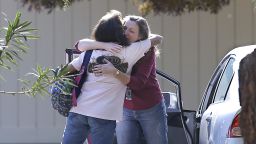 Two women embrace outside Rancho Tehama Elementary School, where a gunman opened fire Tuesday, Nov. 14, 2017, in Corning, Calif. Authorities said, a gunman choosing targets at random, opened fire in a rural Northern California town Tuesday, killing four people at several sites and wounding others at the elementary school before police shot him dead. (AP Photo/Rich Pedroncelli)