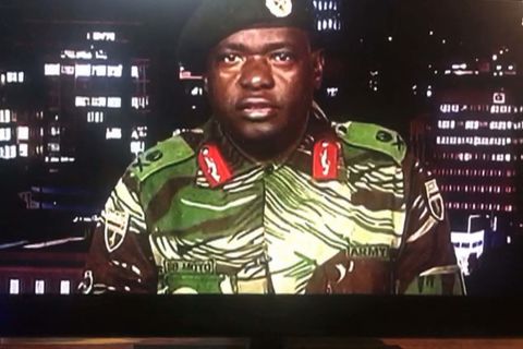 In a screen grab of a TV broadcast on the Zimbabwe Broadcasting Corp., Maj. Gen. Sibusiso Moyo reads a statement saying the military was conducting an operation to target "criminals" close to the President who were causing "social and economic suffering." He denied a coup was underway.