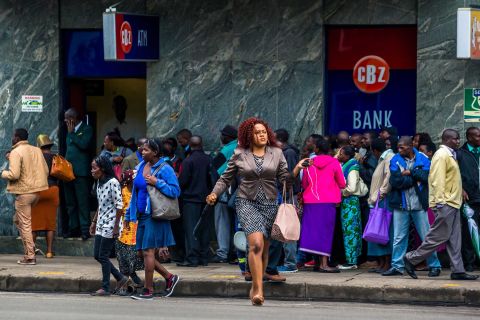 Residents in Zimbabwe's capital line up to withdraw money from a bank on November 15.