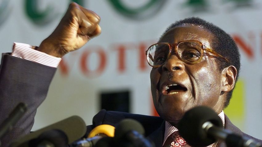 HARARE, ZIMBABWE: Zimbabwean President Robert Mugabe clenches his fist to salute Zanu PF comrades in Harare, 03 May 2000. Mugabe launched his ruling party election manifesto today ahead the upcoming elections. (ELECTRONIC IMAGE) AFP PHOTO ODD ANDERSEN. (Photo credit should read ODD ANDERSEN/AFP/Getty Images)
