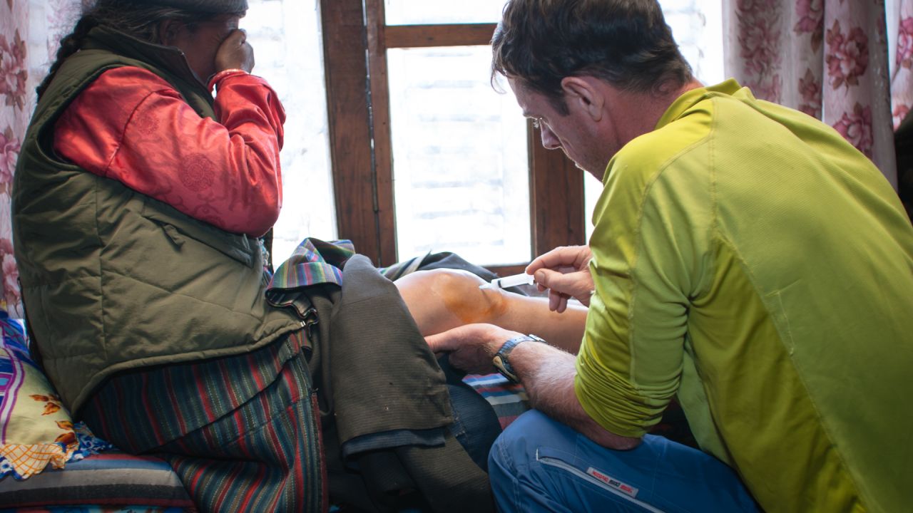 <strong>Mountains calling</strong>: Peacock started working on expeditions after he developed a passion for rock climbing, which lead to a love of mountaineering. <em>Pictured here: Peacock injecting the knee of an elderly Sherpa woman in Nepal </em>