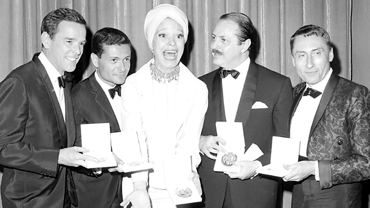 Channing celebrates her Tony win alongside "Hello Dolly!" director Gower Champion, composer and lyricist Jerry Herman, producer David Merrick and costume designer Freddy Wittop in 1964. The original production won 10 Tony Awards.