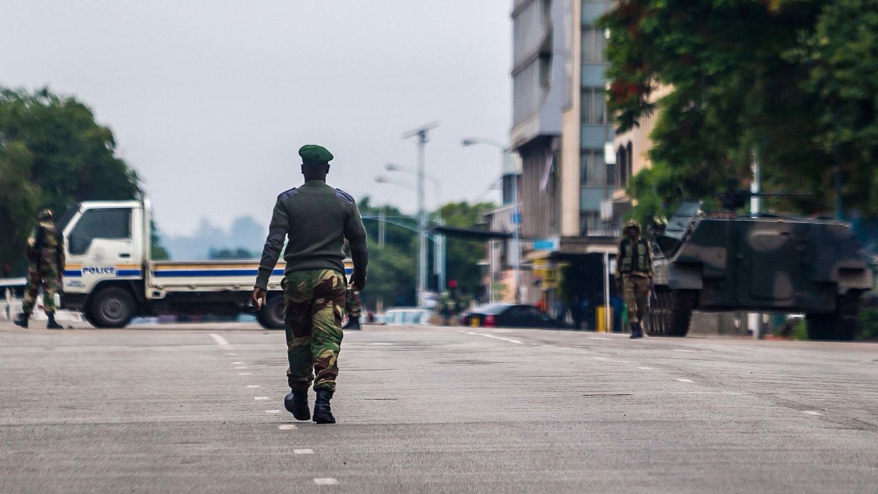 Zimbabwean soldiers stand at an intersection as they regulate traffic in Harare on November 15, 2017. 
Zimbabwe's military appeared to be in control of the country on November 15 as generals denied staging a coup but used state television to vow to target "criminals" close to President Mugabe. / AFP PHOTO / Jekesai NJIKIZANA        (Photo credit should read JEKESAI NJIKIZANA/AFP/Getty Images)