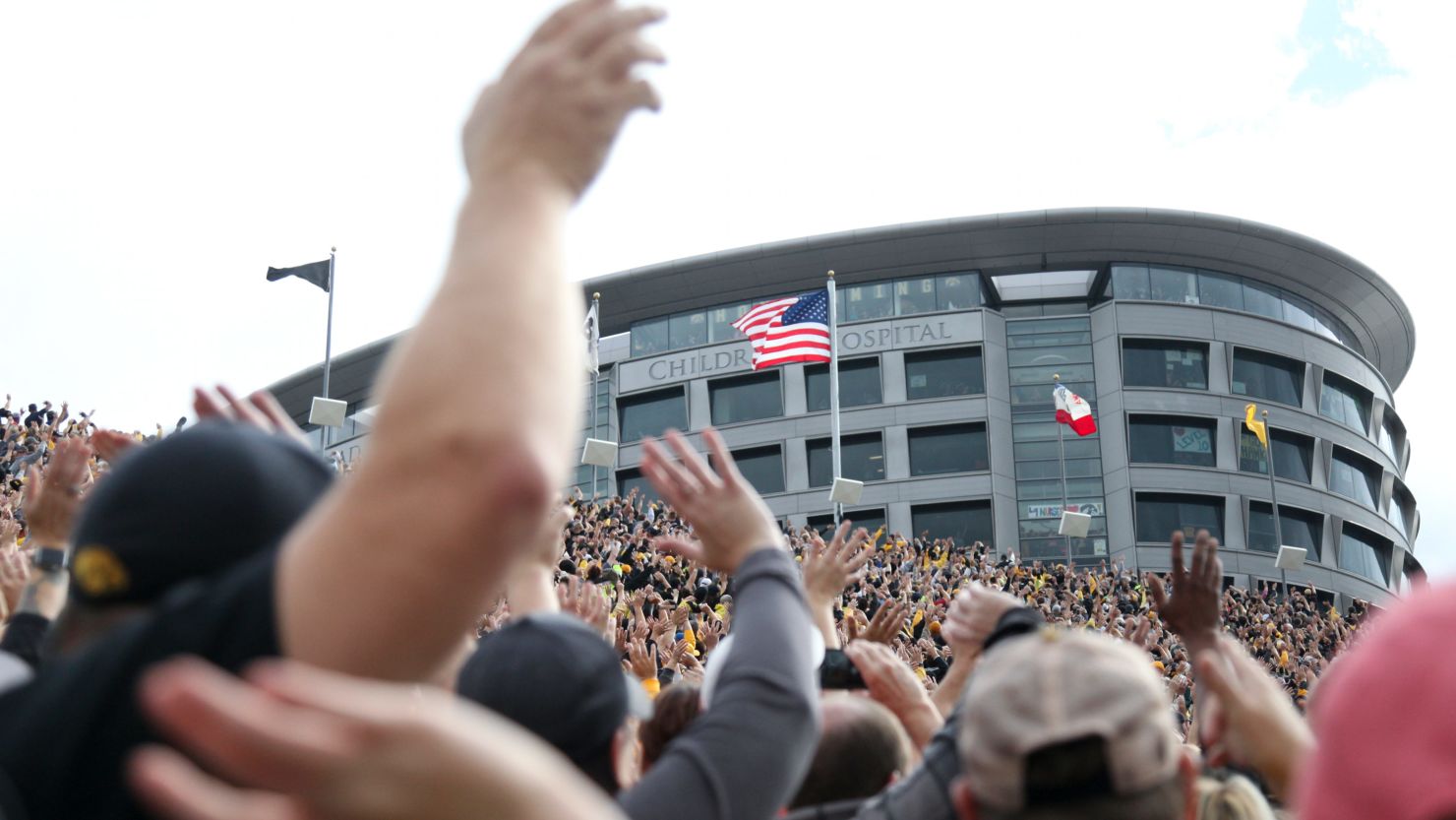 Fans at Iowa's Kinnick Stadium wave to the children watching from the nearby University of Iowa Stead Family Children's Hospital. 