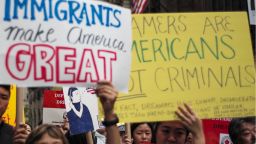Protesters hold up signs during a demonstration against US President Donald Trump during a rally in support of the Deferred Action for Childhood Arrivals (DACA), also known as Dream Act, near the Trump Tower in New York on October 5, 2017.  / AFP PHOTO / Jewel SAMAD        (Photo credit should read JEWEL SAMAD/AFP/Getty Images)