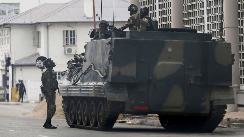 A military vehicle is seen on a street in Harare, Zimbabwe, Thursday, Nov. 16, 2017. People across the country are starting another day of uncertainty amid quiet talks to resolve the country's political turmoil and the likely end of President Robert Mugabe's decades-long rule. Mugabe has been in military custody and there is no sign of the recently fired deputy Emmerson Mnangagwa, who fled the country last week. (AP Photo)