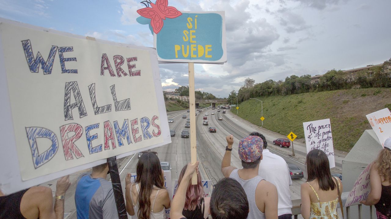 LOS ANGELES, CA - SEPTEMBER 10: People hold signs over the 110 freeway as thousands of immigrants and supporters join the Defend DACA March to oppose the President Trump order to end DACA on September 10, 2017 in Los Angeles, California. The Obama-era Deferred Action for Childhood Arrivals program provides undocumented people who arrived to the US as children temporary legal immigration status for protection from deportation to a country many have not known, and a work permit for a renewable two-year period. The order exposes about 800,000 so-called òdreamersó who signed up for DACA to deportation. About a quarter of them live in California. Congress has the option to replace the policy with legislation before DACA expires on March 5, 2018.  (Photo by David McNew/Getty Images)