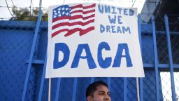 DACA recipient and appliance repair business owner Erick Marquez holds a sign during a protest in support of DACA (Deferred Action for Childhood Arrivals) which provides protection from deportation for young immigrants brought into the US illegally by their parents, September 10, 2017 in Los Angeles, California. / AFP PHOTO / Robyn Beck        (Photo credit should read ROBYN BECK/AFP/Getty Images)