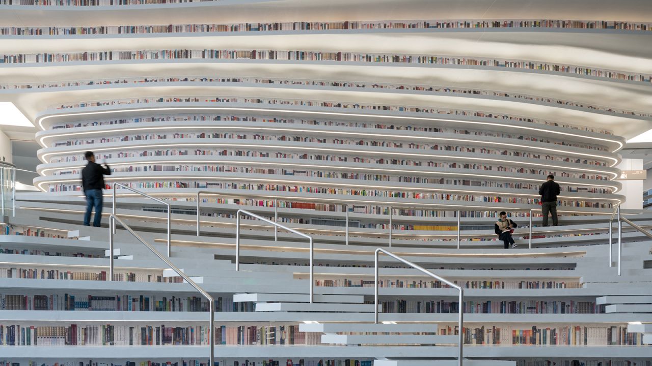 <strong>No heels, no non-hikers: </strong>The curvy contours surrounding the sphere host myriad bookshelves. They also act as stairs and seating to form a massive book mountain. The library advises that readers under the age of 14, and those who wear heels or are unfit for hiking shouldn't climb the book mountain.