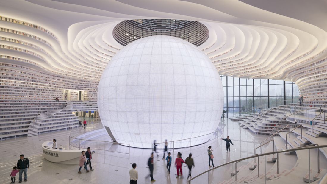 The new structure has a sleek futuristic design featuring a luminous spherical auditorium space in the center, created by the Dutch architecture firm MVRDV and Tianjin's Urban Planning Design Institute.