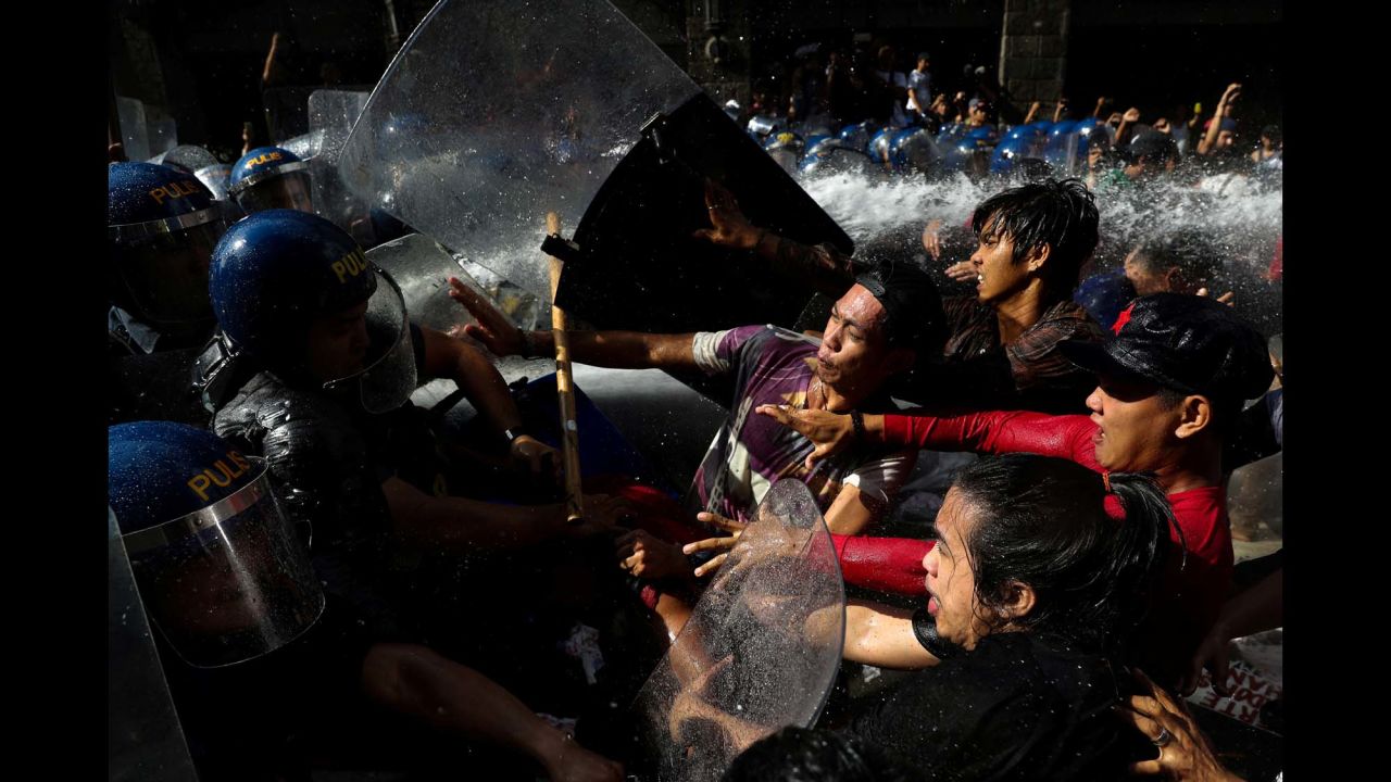 Protesters clash with police as they try to march toward the US Embassy in Manila, Philippines, on Sunday, November 12. The protesters were rallying against the visit of US President Donald Trump.