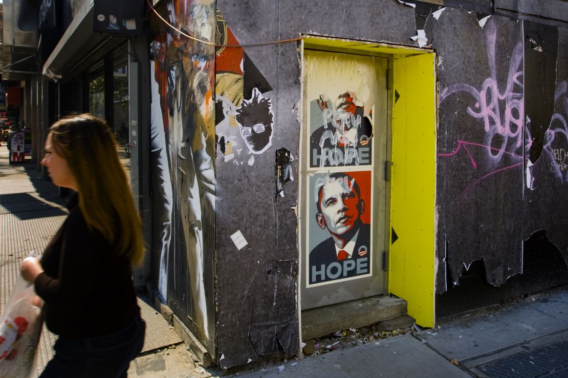A pedestrian walks past a poster of Barack Obama October 9, 2008 in New York City.