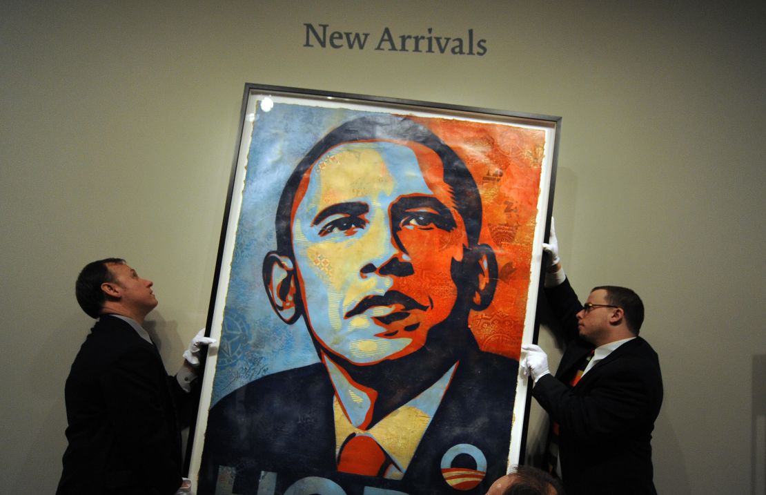 Workers install Shepard Fairey's portrait of US President-elect Barack Obama at the National Portrait Gallery in Washington on January 17, 2009.