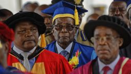 Zimbabwe's President Robert Mugabe, center, arrives to preside over a student graduation ceremony at Zimbabwe Open University on the outskirts of Harare, Zimbabwe on Friday. Mugabe is making his first public appearance since the military put him under house arrest earlier this week.