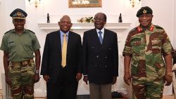 This screengrab from Zimbabwe Broadcasting Corporation (ZBC) taken on November 16, 2017, shows Zimbabwe President Robert Mugabe (2R) as he poses alongside Zimbabwe Defence Forces Commander General Constantino Chiwenga (R) and South African envoys at State House in Harare. 
Zimbabweans face an uncertain future without President Robert Mugabe after the army took power and placed the 93-year-old liberation hero turned authoritarian leader under house arrest. / AFP PHOTO / ZBC / - / RESTRICTED TO EDITORIAL USE - MANDATORY CREDIT "AFP PHOTO / ZBC" - NO MARKETING NO ADVERTISING CAMPAIGNS - DISTRIBUTED AS A SERVICE TO CLIENTS- NO RESALE 

-/AFP/Getty Image