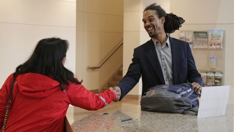 Braxton Winston, right, greets a supporter as he arrives for an orientation meeting at the government center in Charlotte, N.C., Thursday, Nov. 9, 2017.